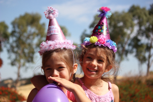 young girls in party hats